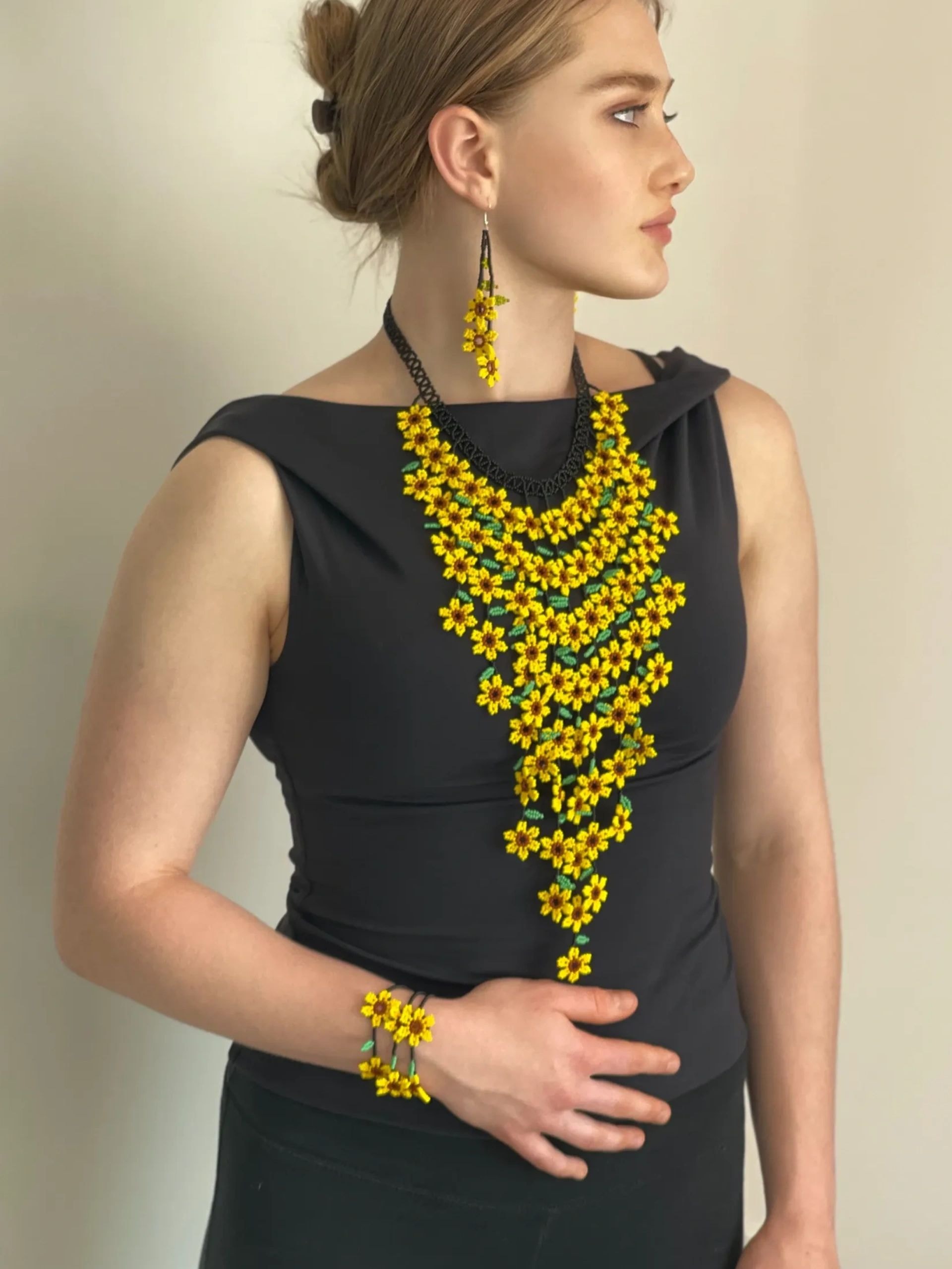 New products - woman wearing yellow beaded jewelry